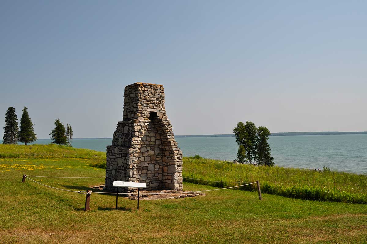 stone chimney on hill overlooking water