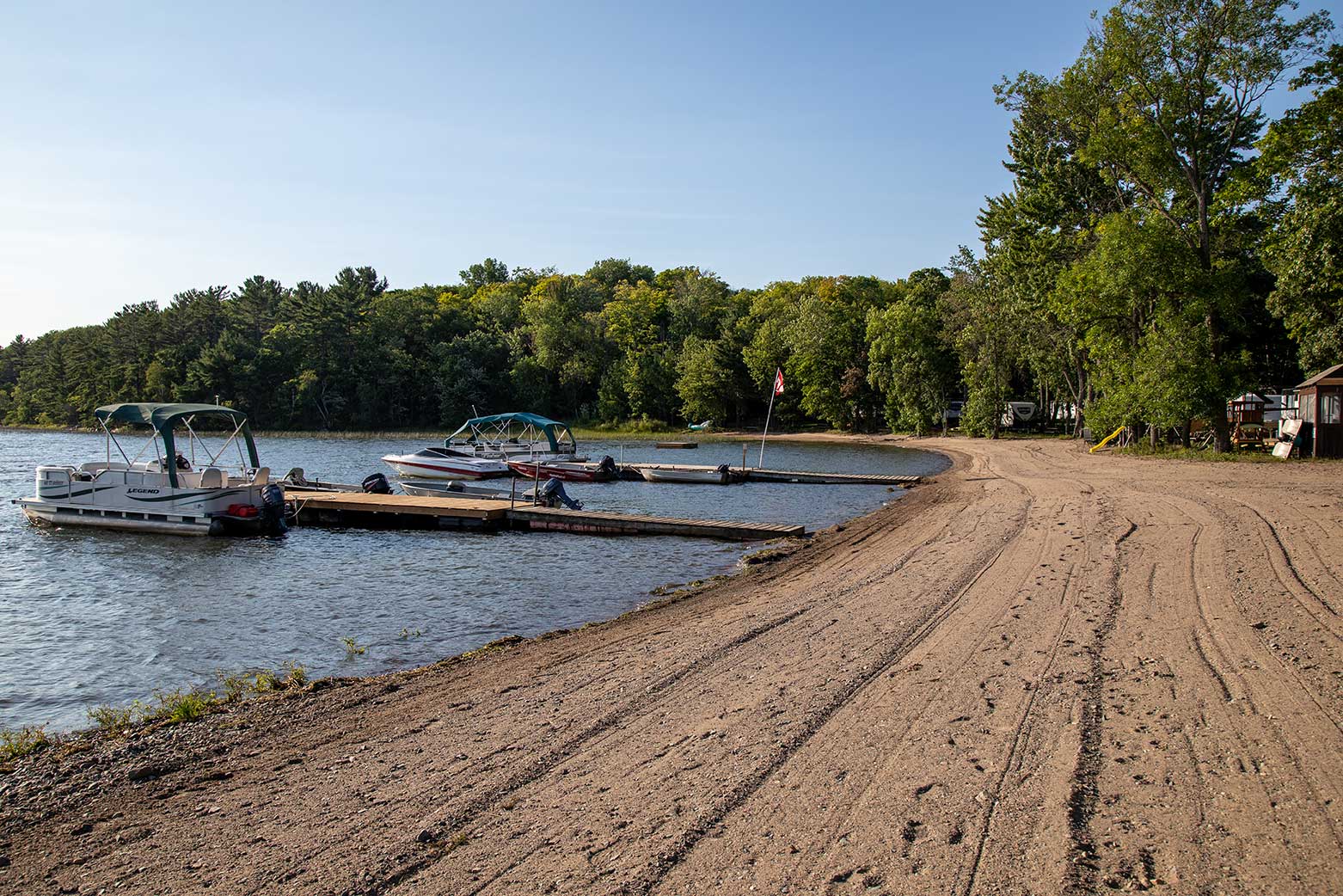 beach with dock and two boats