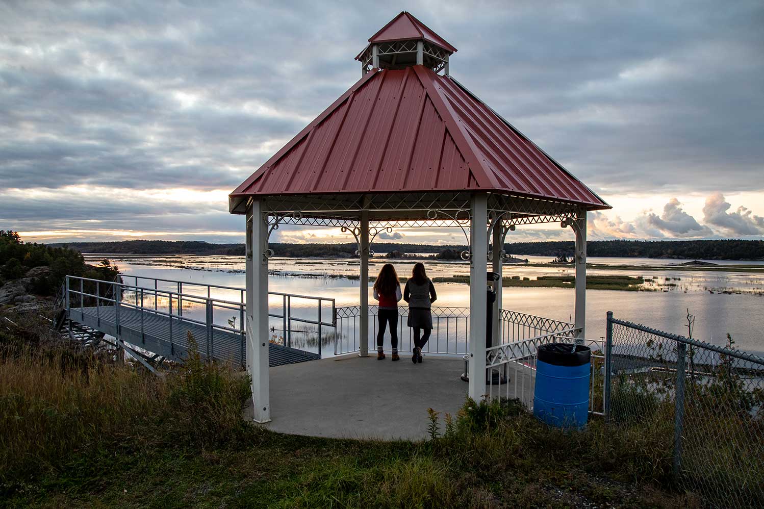 red roofed gazebo overlooking water vista