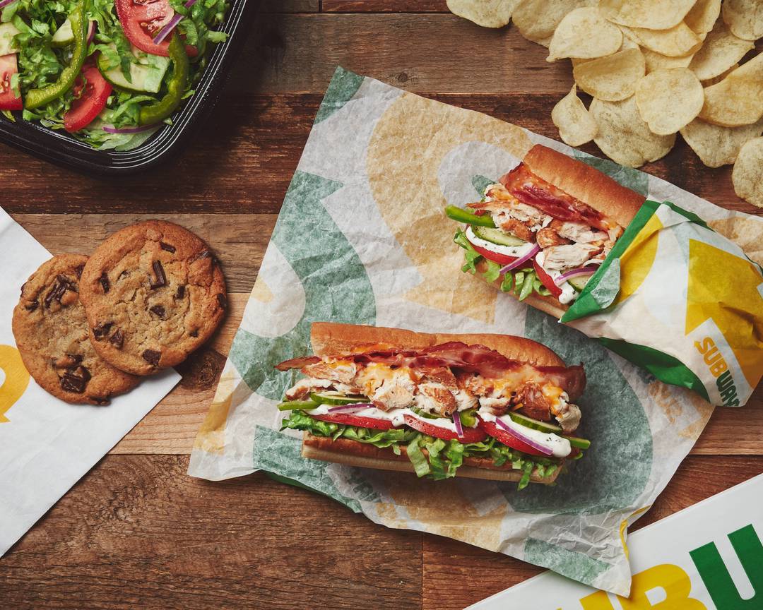 Subway sandwich with cookies, chips and salad