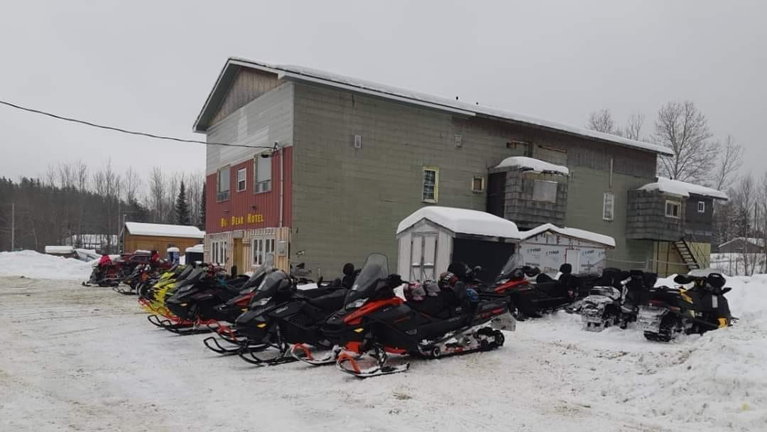 Exterior of building with snowmobiles