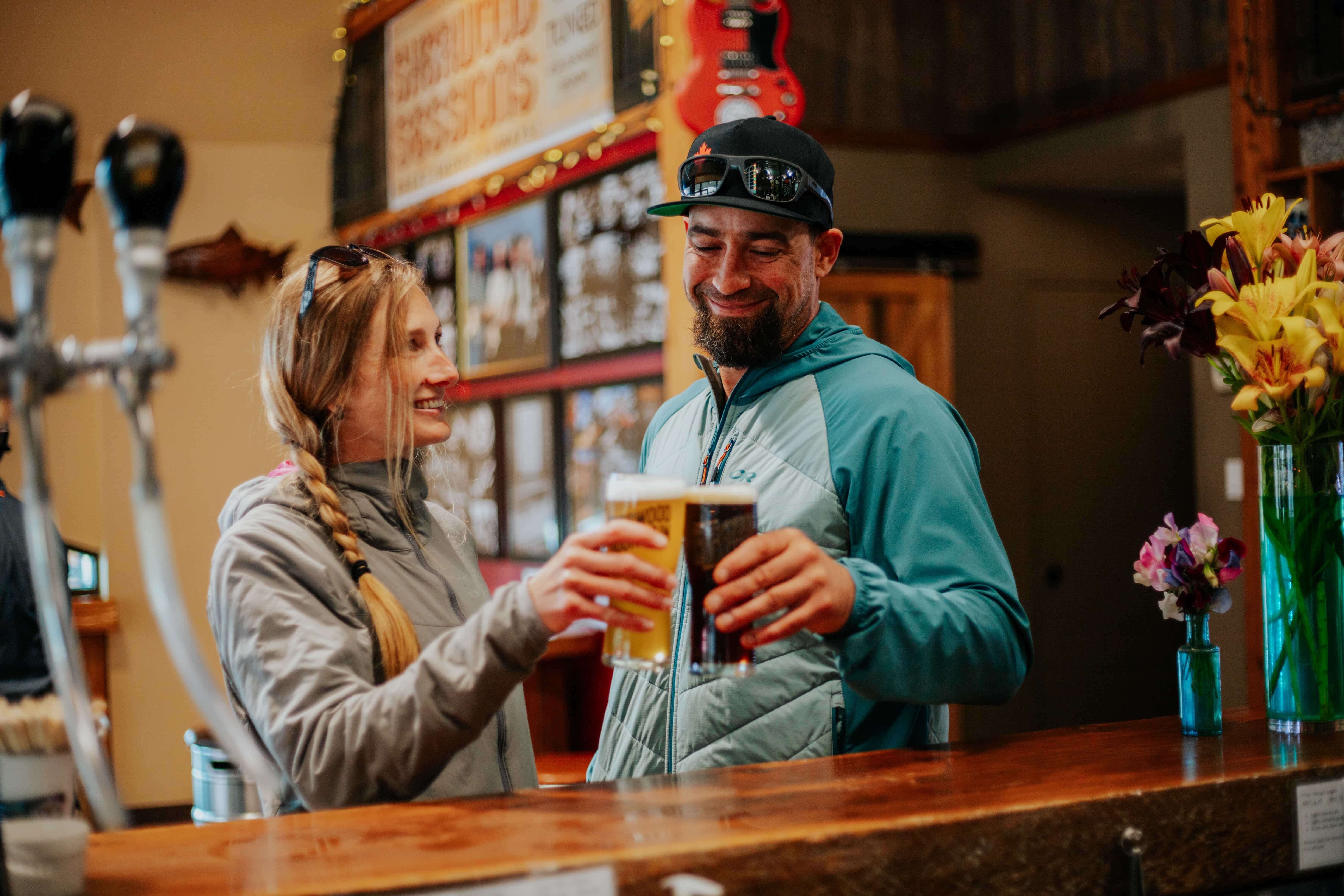 people holding two pints of beer together