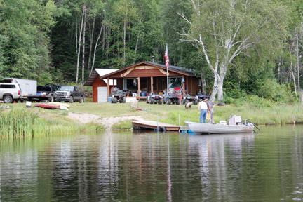 Cabin on lake with boat