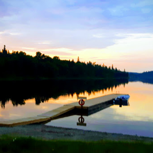 Dock in water at sunset