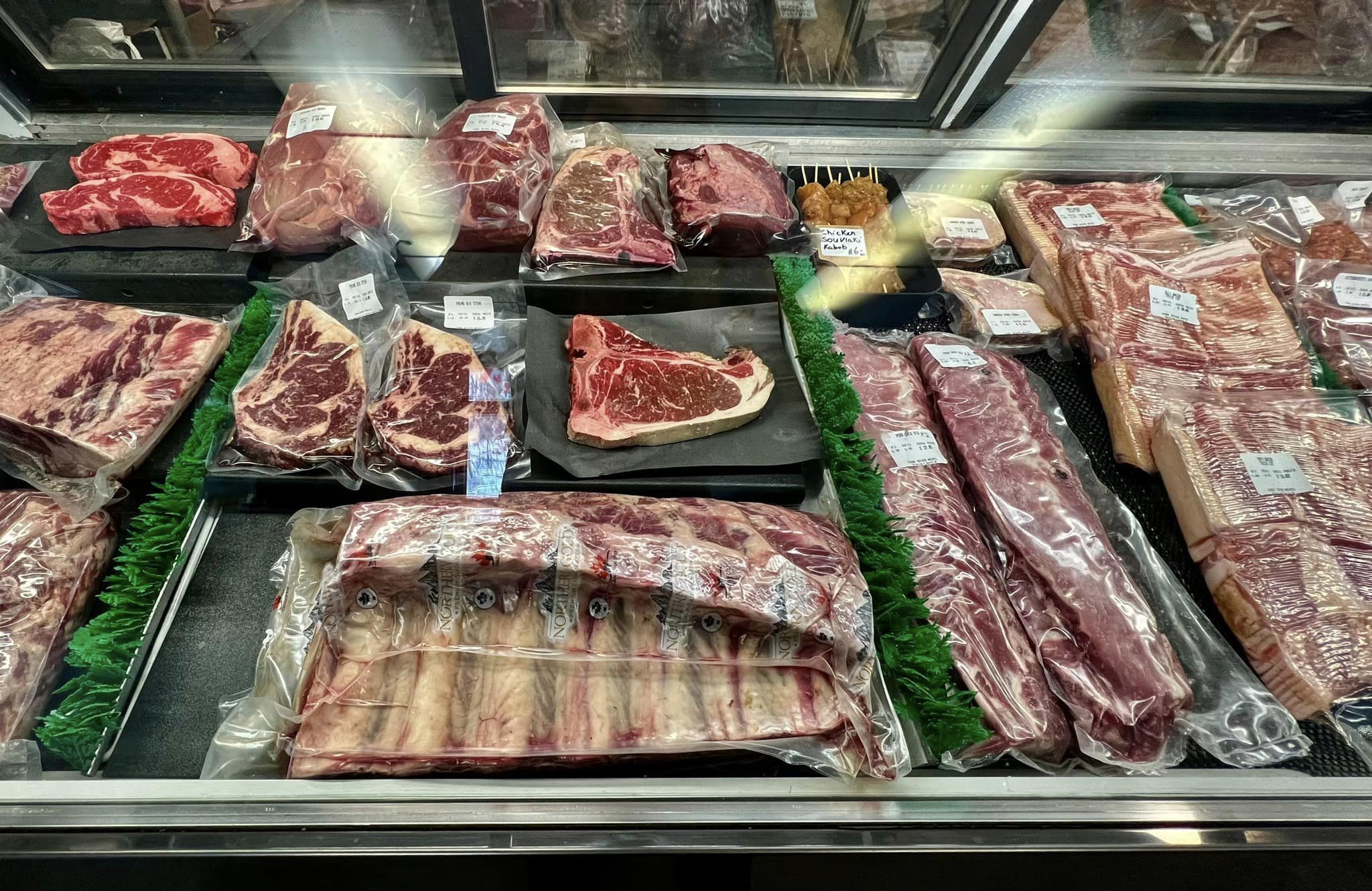 cuts of meat in a butcher shop display fridge