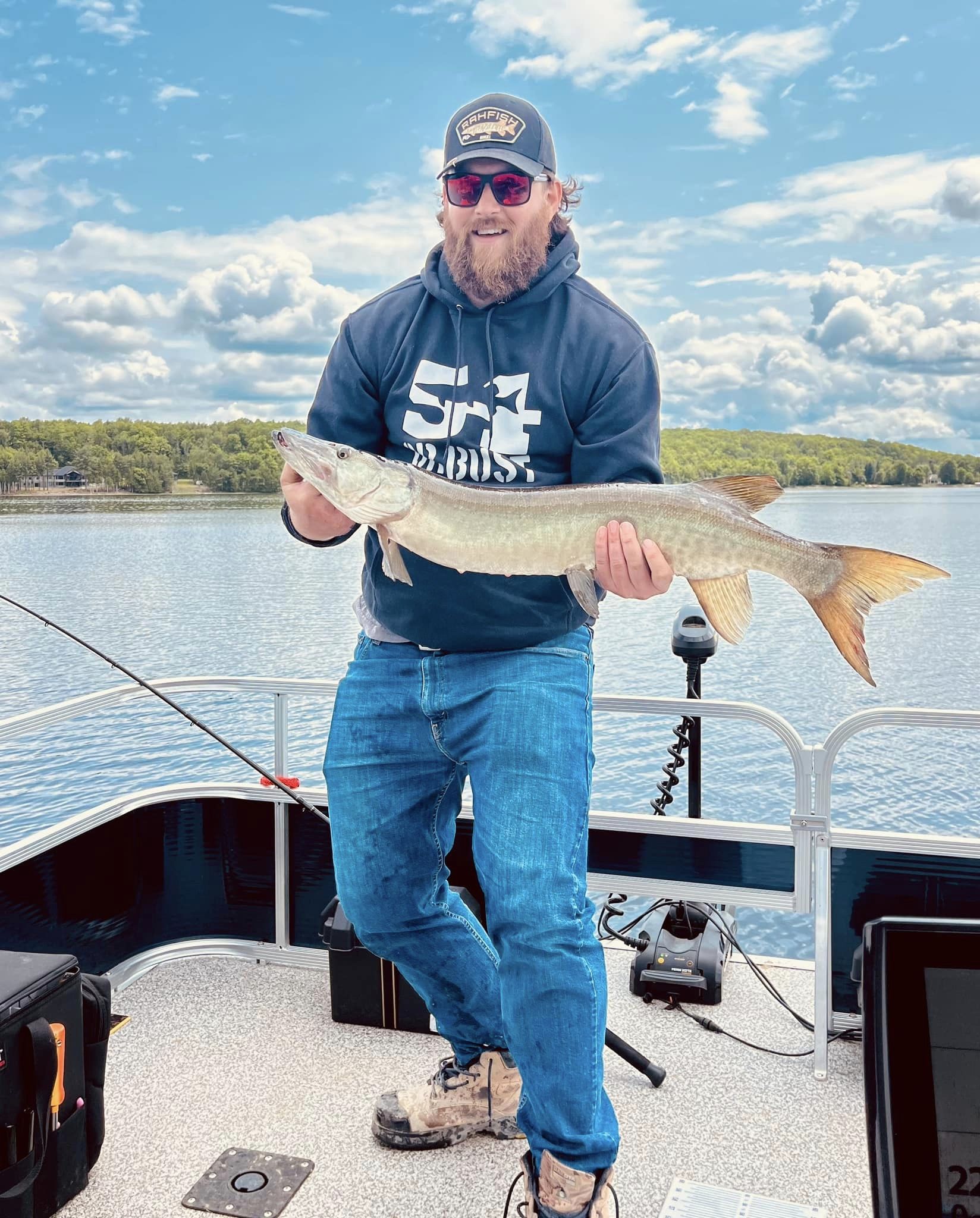 Man holding a fish on a boat