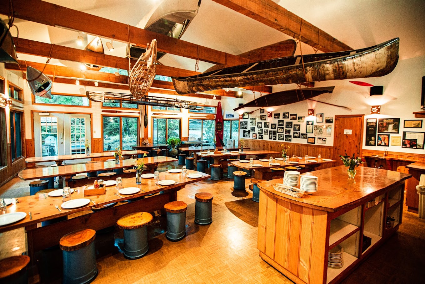 cozy wood-lined cafeteria with canoes hanging from the ceiling