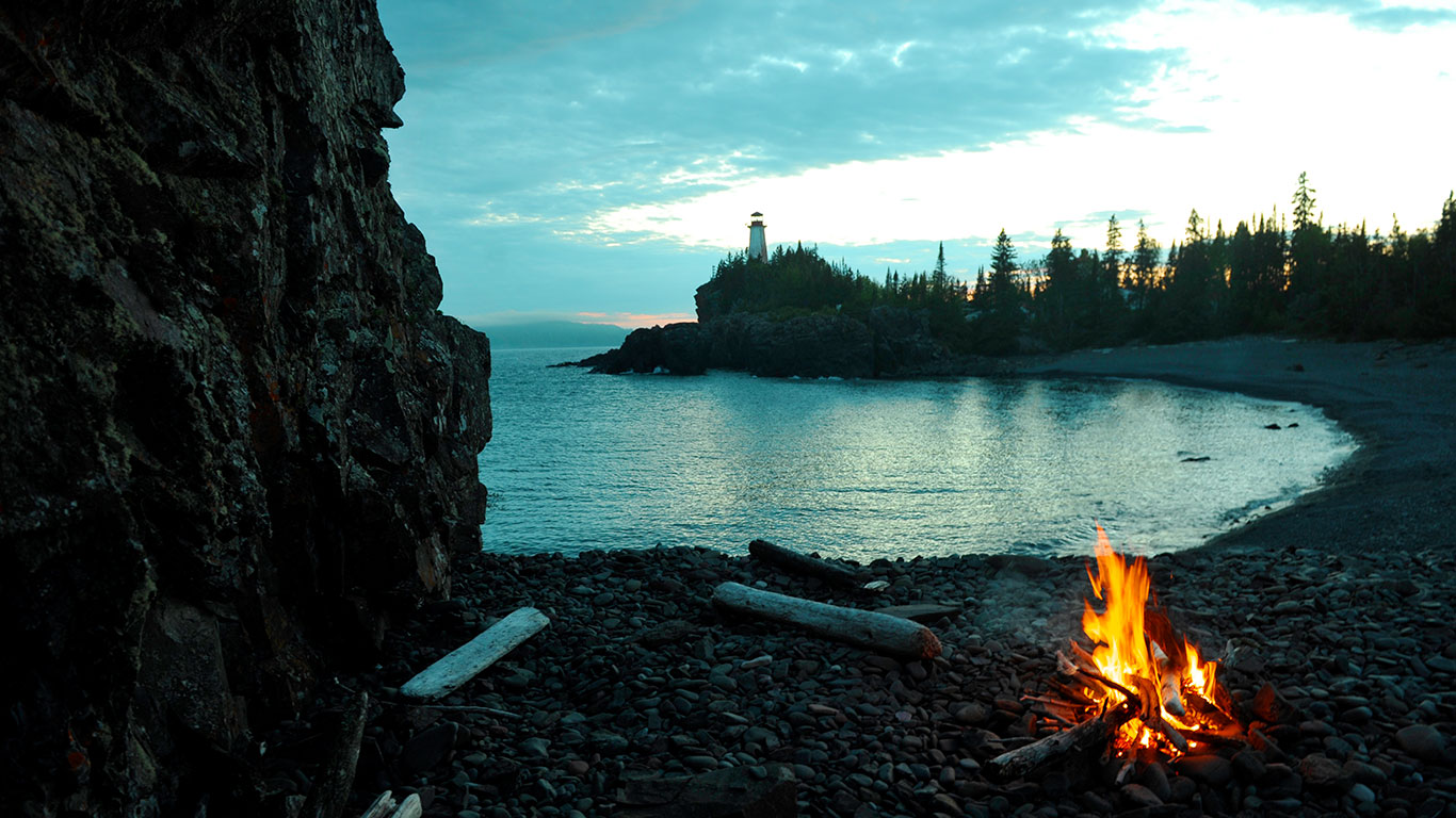 A fire on a beach at dusk