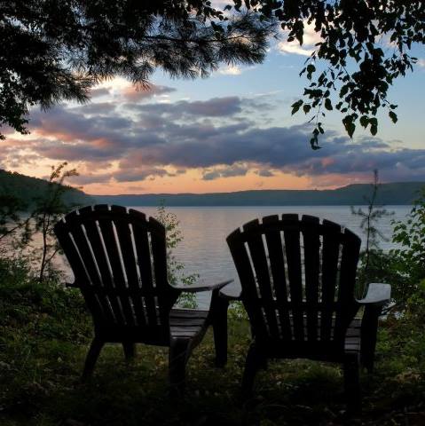 Chairs next to the lake at sunset