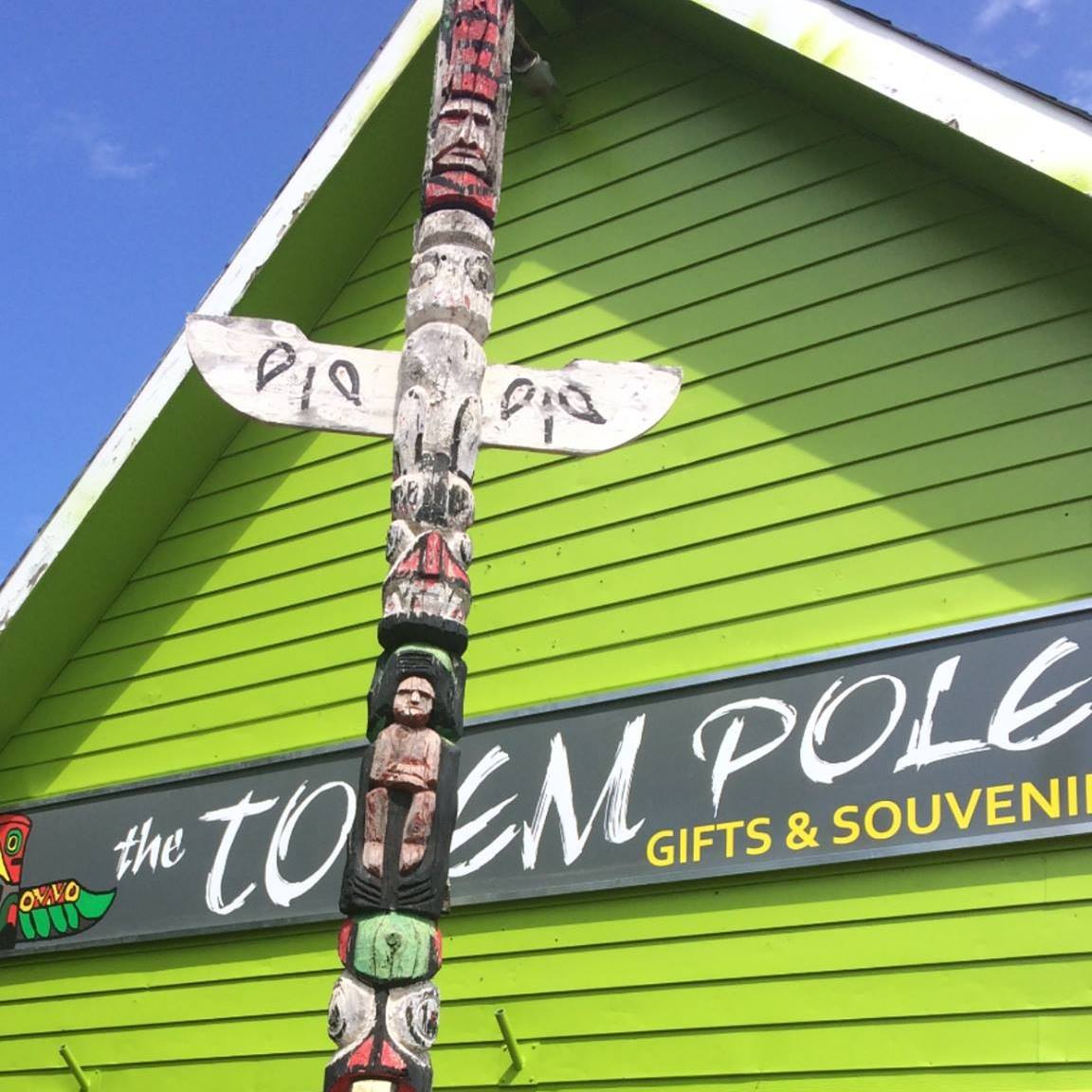 Exterior of building with sign and totem pole