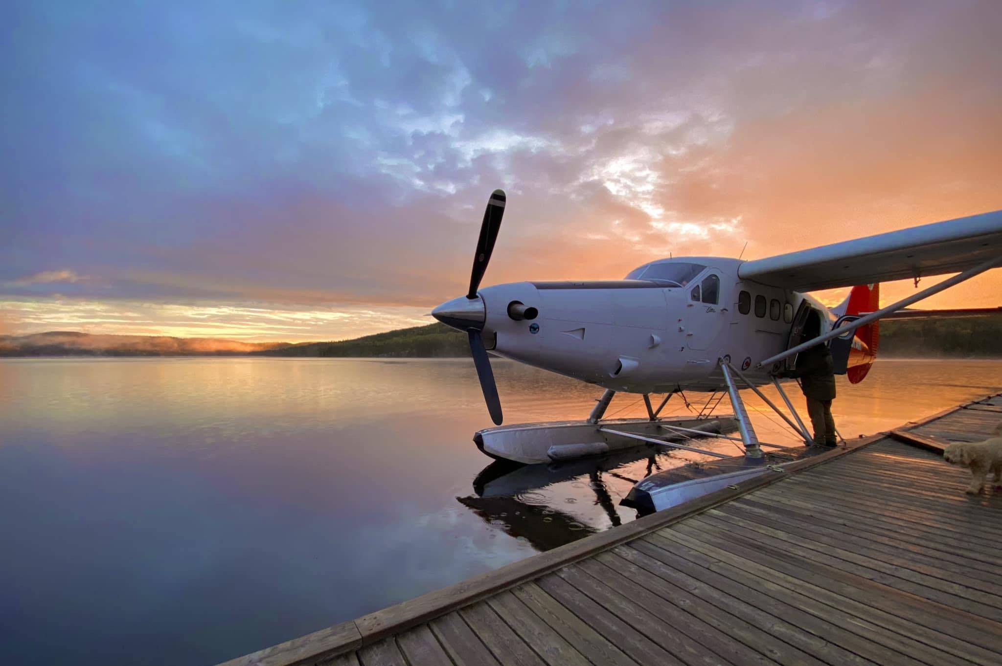 Float plane parked at dock at sunset