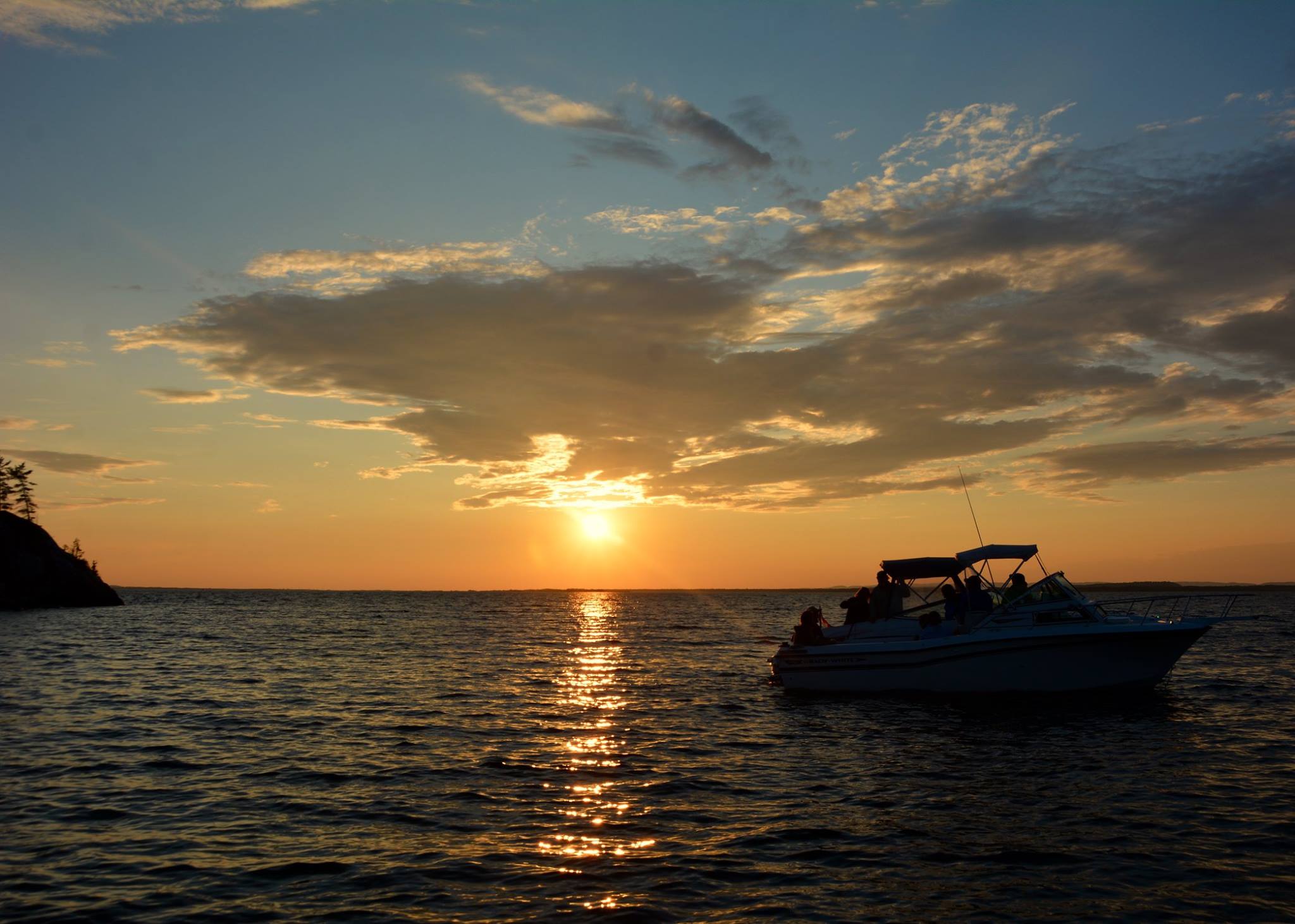 a boat on the water in the sunset