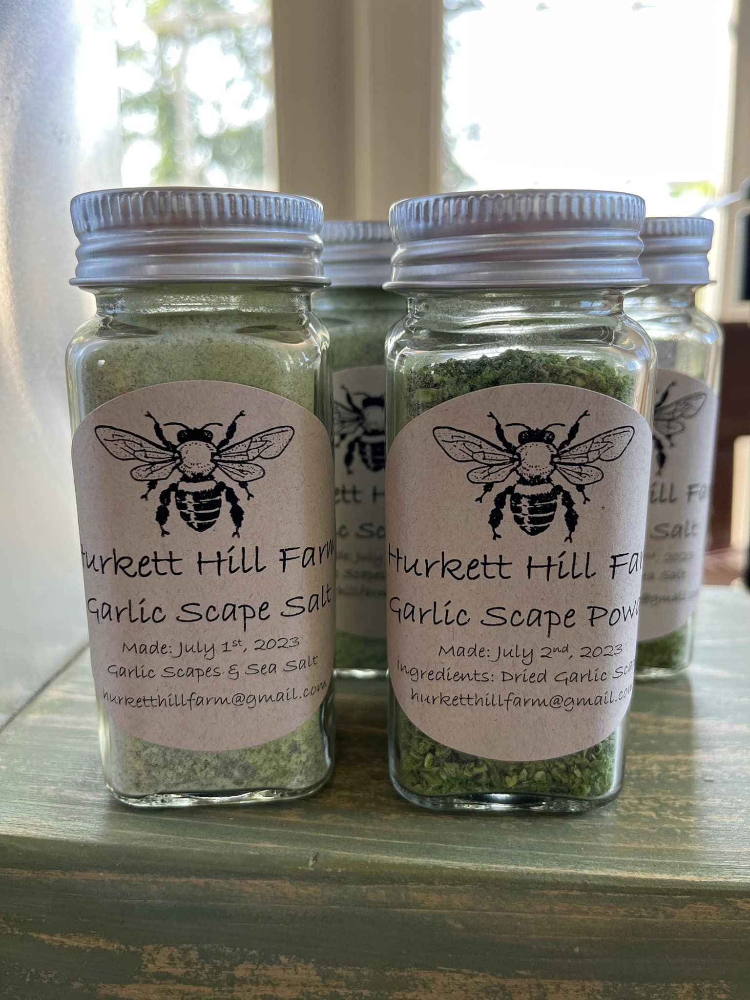 Jars of dried herbs with logo