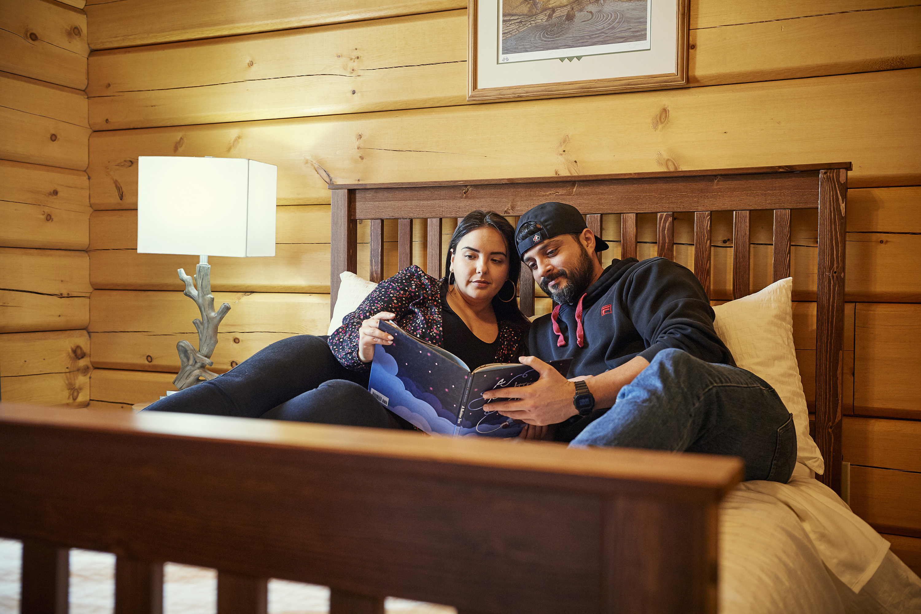 two people laying in a bed