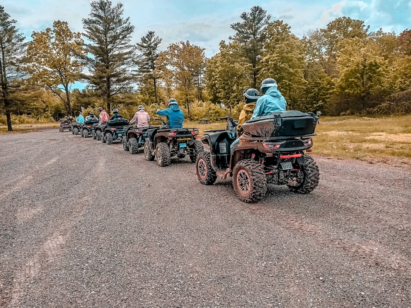 a group of people on atvs driving a trail