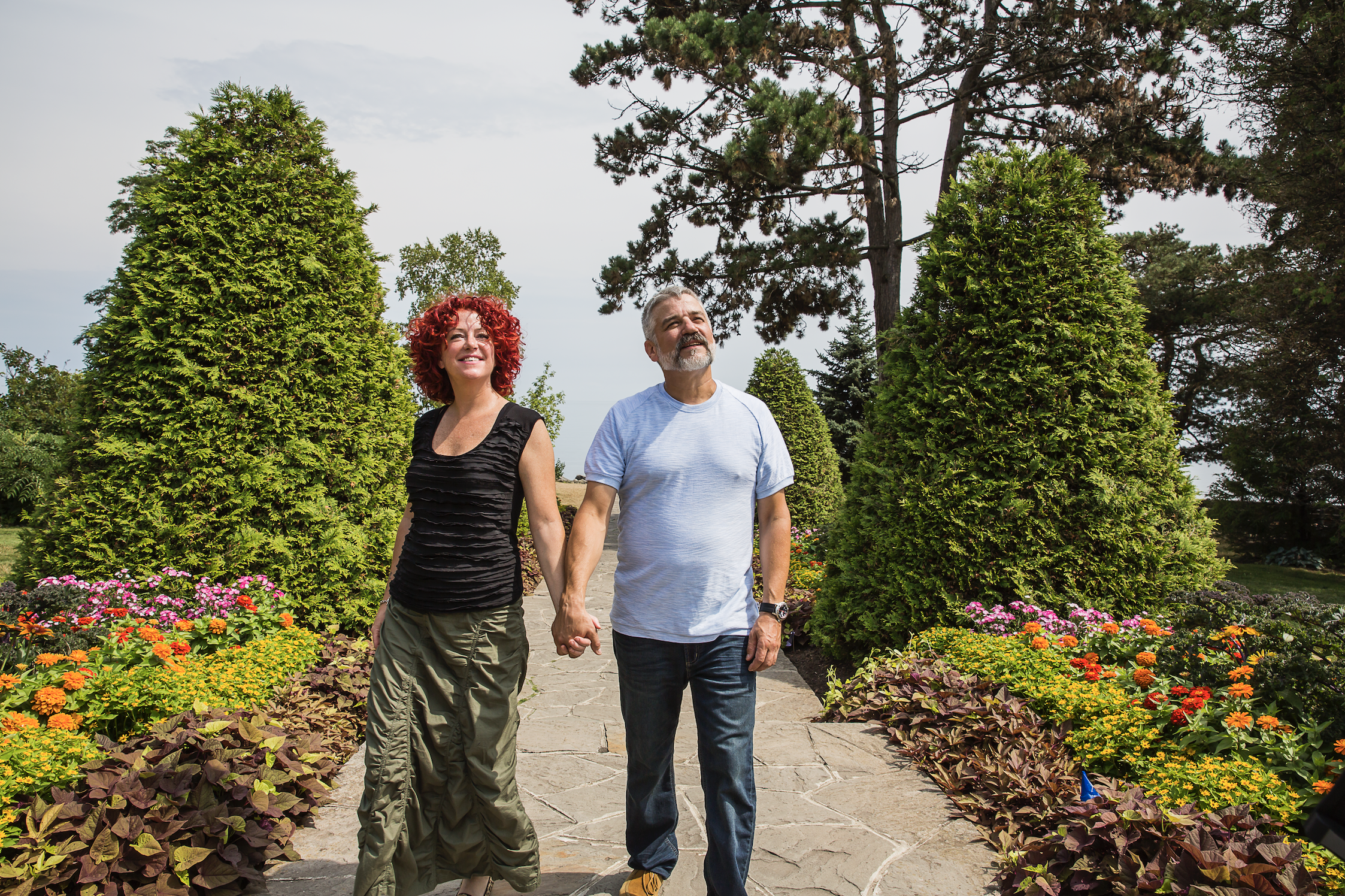 a couple walking through a garden