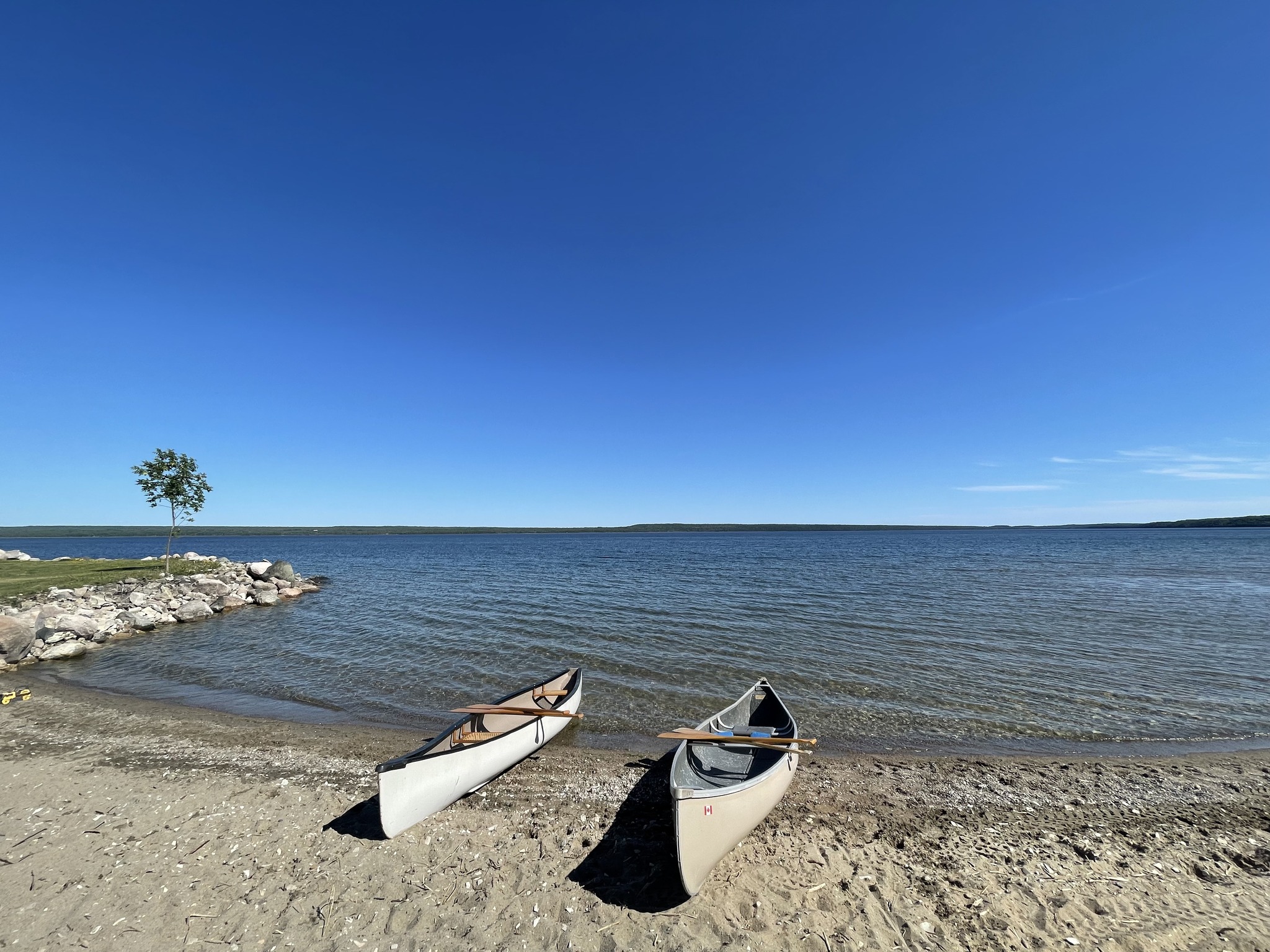 Beachfront with two canoes on shore