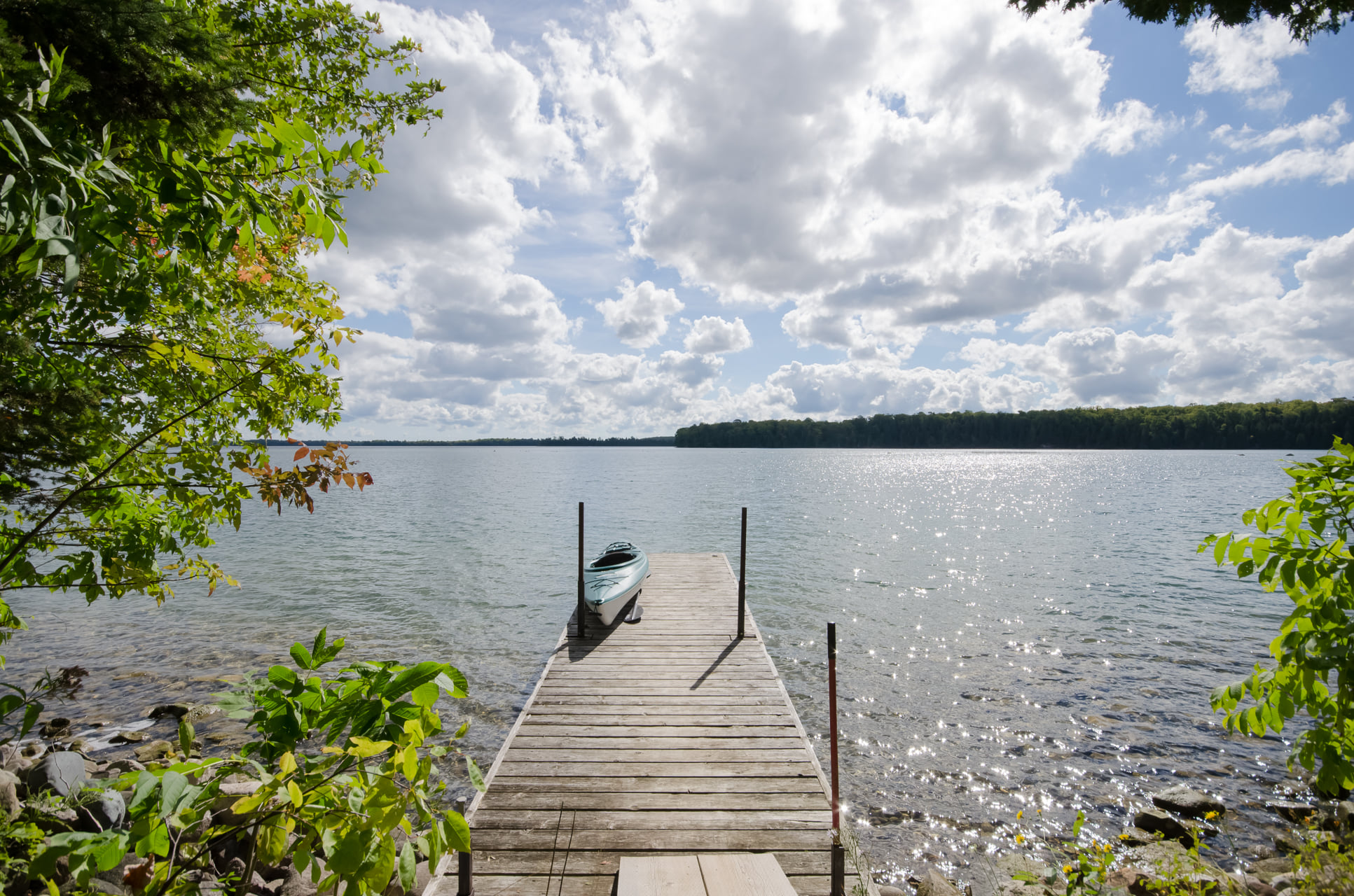 View of lake with dock and kayak