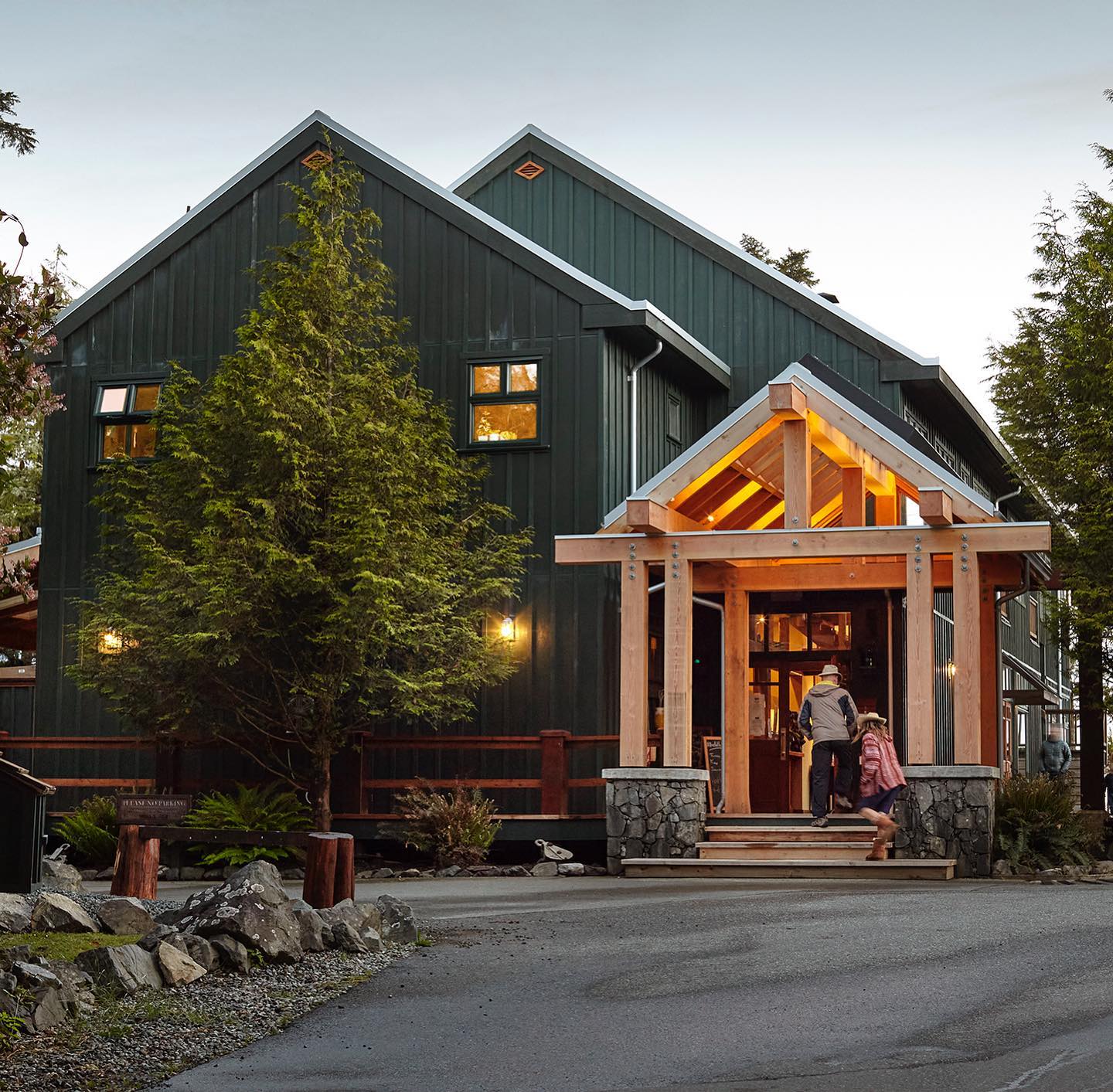 two people walking into large lodge resort