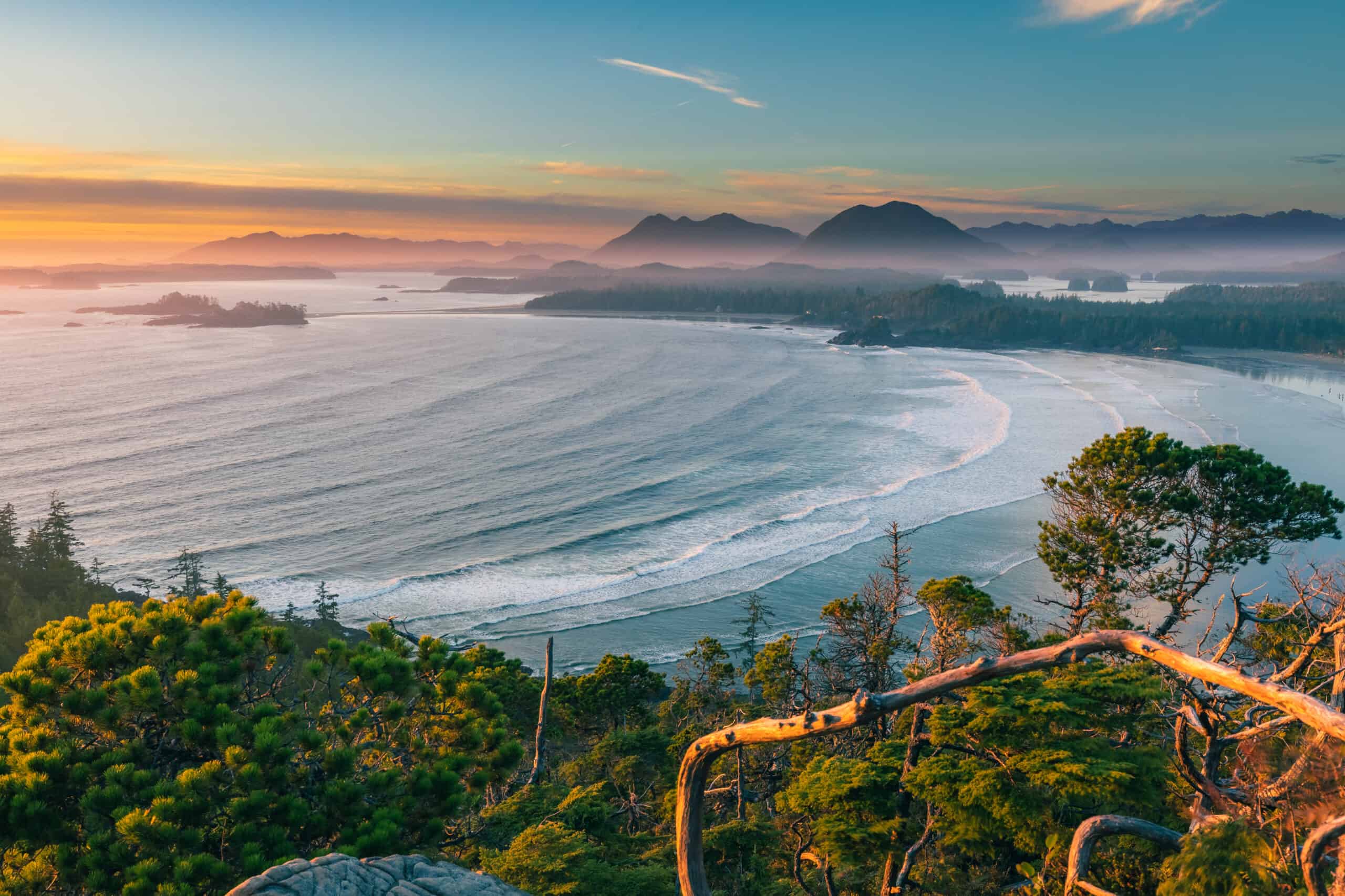 Cox Bay Lookout at sunset, with calm blue waves and turquoise sky