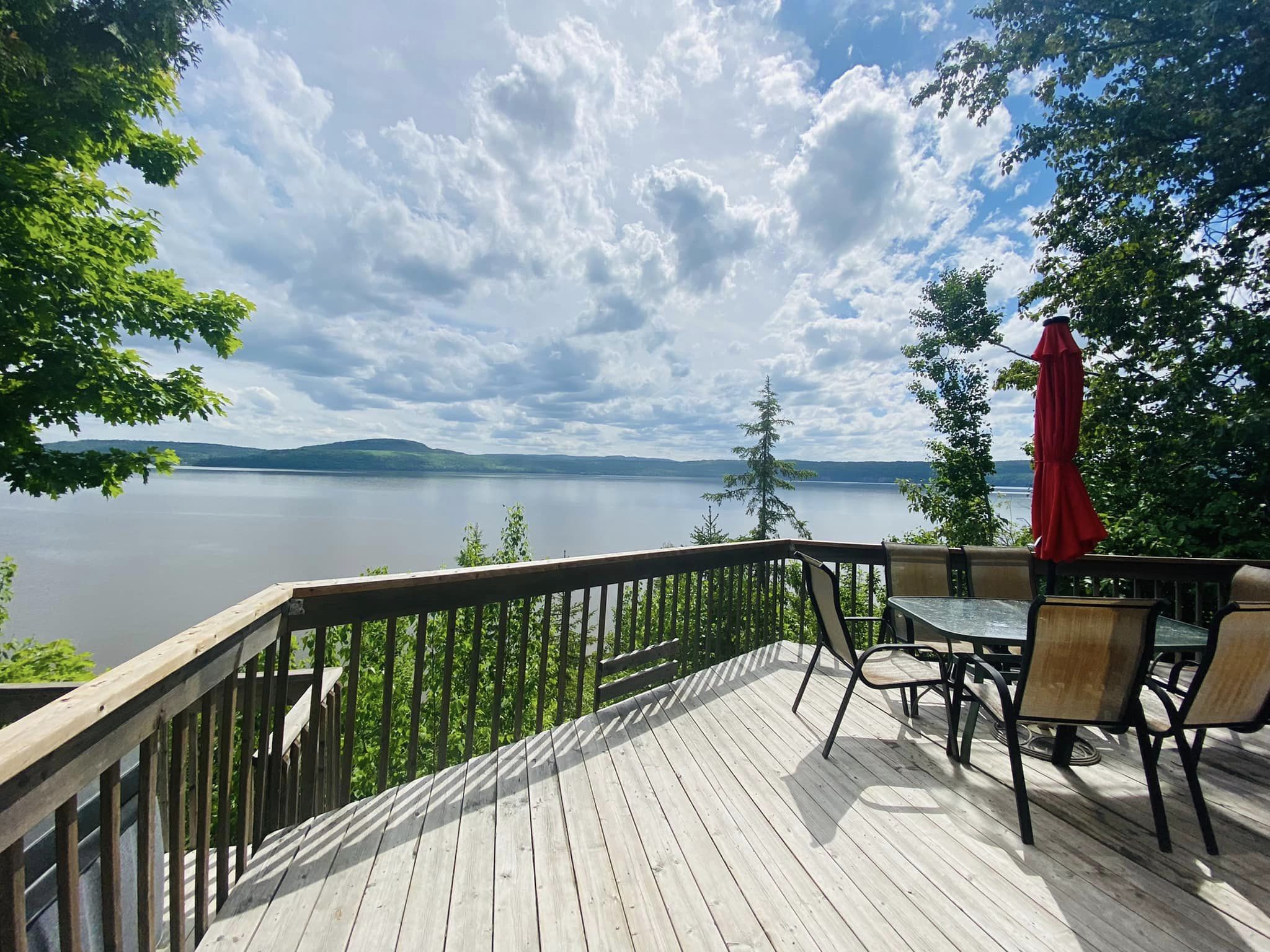 Deck with patio chairs looking out over lake