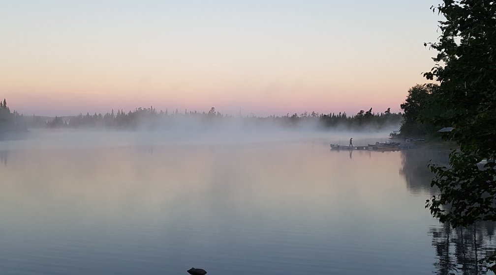 Lake view at sunrise with fog