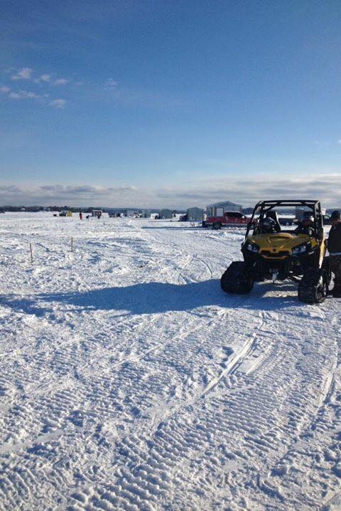 Ice huts on lake with ATV