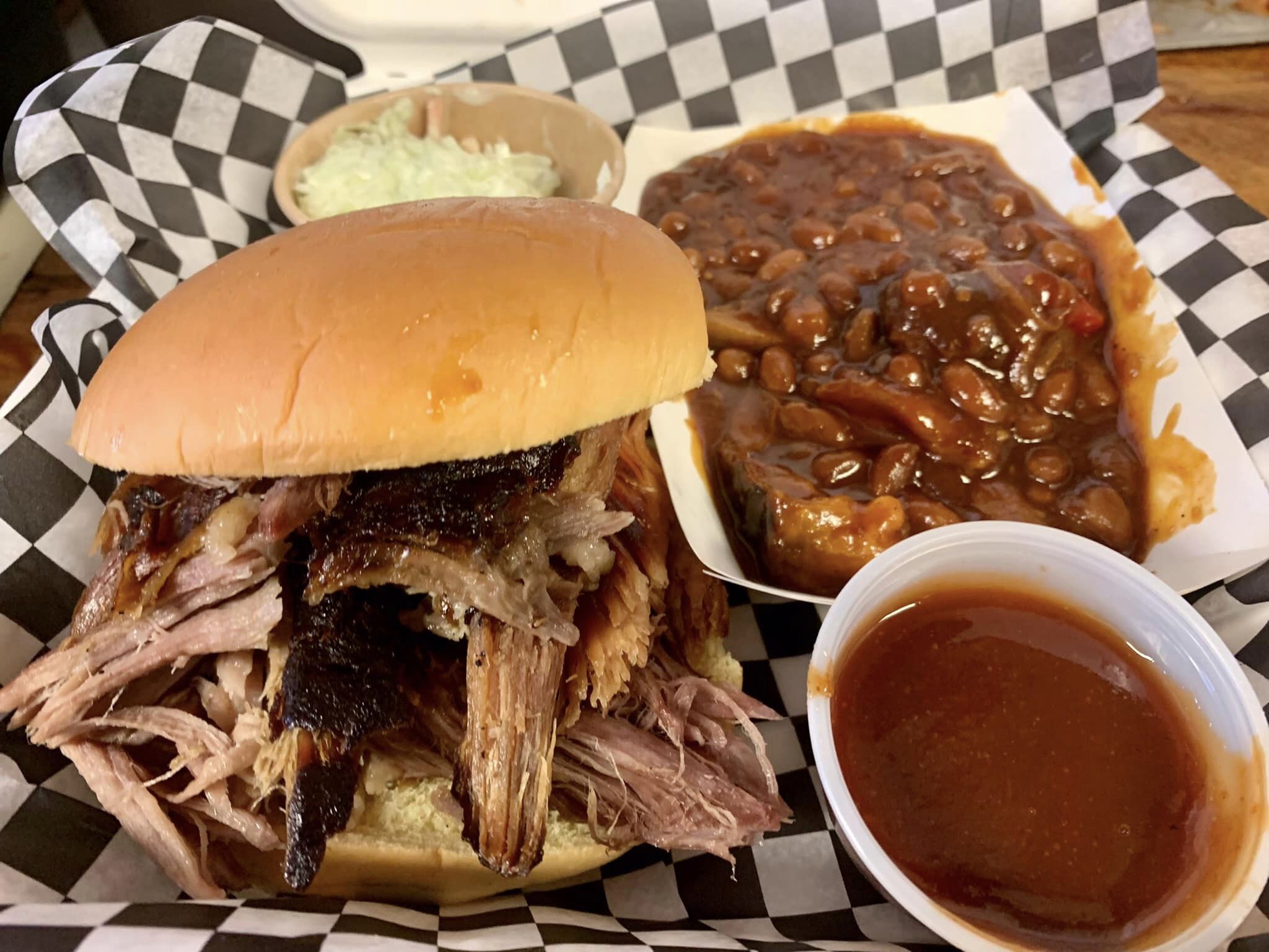 Pulled pork on bun with baked beans