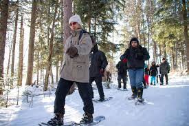 People snowshoeing along trails