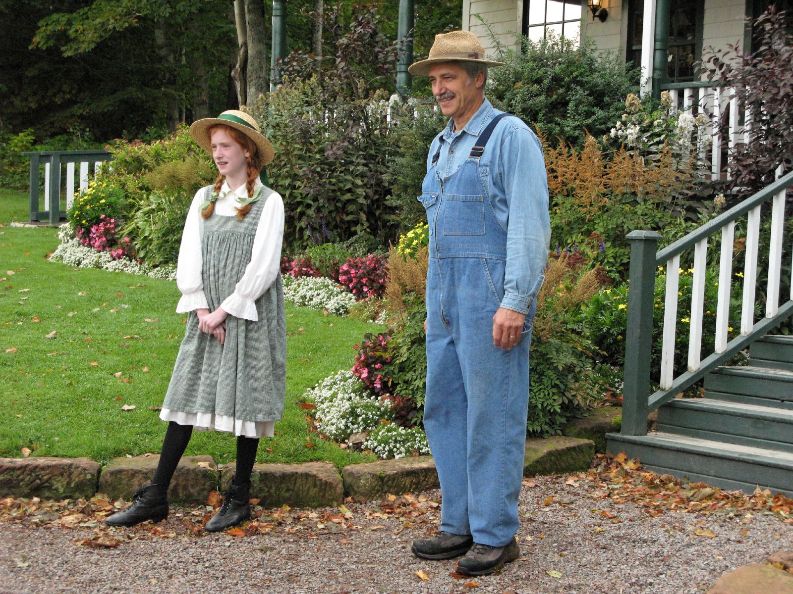 two statues in front of a porch