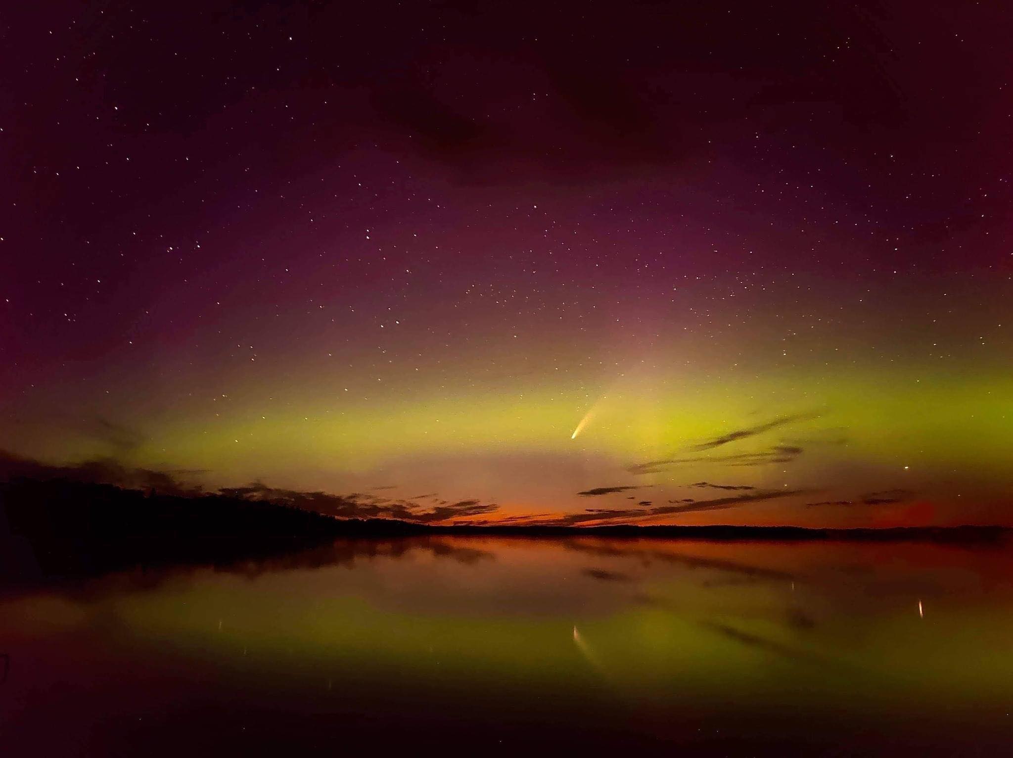 Shooting star over water at night.