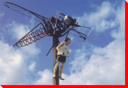 Giant Mosquito statue carrying a man 