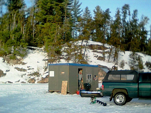 Ice fishing hut on frozen lake