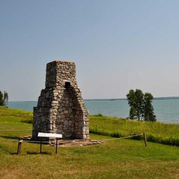 stone chimney on hill overlooking water