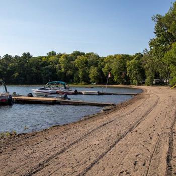 beach with dock and two boats