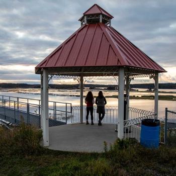 red roofed gazebo overlooking water vista