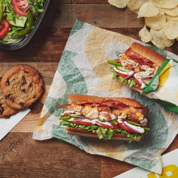 Subway sandwich with cookies, chips and salad