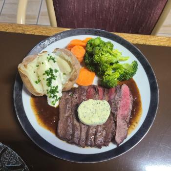 Steak, veggies and potatoes on plate