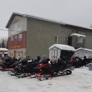 Exterior of building with snowmobiles