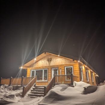 Cabin at night with snow