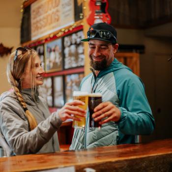 people holding two pints of beer together