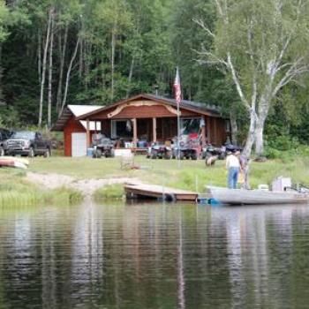 Cabin on lake with boat