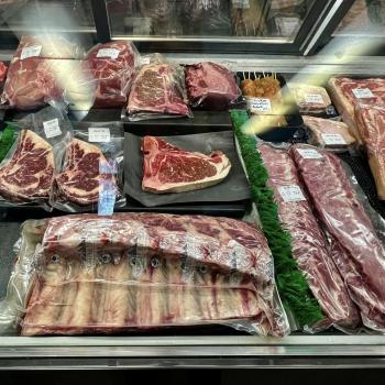 cuts of meat in a butcher shop display fridge