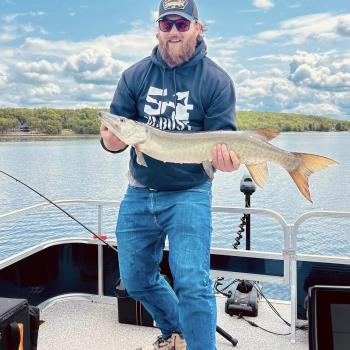 Man holding a fish on a boat