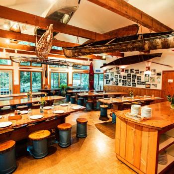 cozy wood-lined cafeteria with canoes hanging from the ceiling