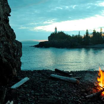 A fire on a beach at dusk