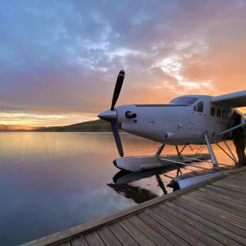 Float plane parked at dock at sunset