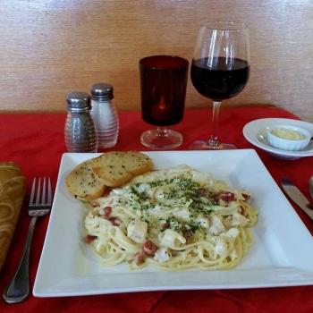 Pasta with bread and a glass of wine