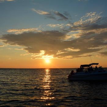 a boat on the water in the sunset