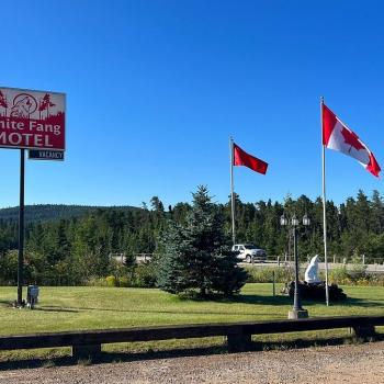 Grass frontage of motel with sign